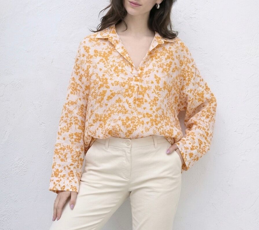 Loose-fitting bohemian blouse with long sleeves, shirt collar, and floral print