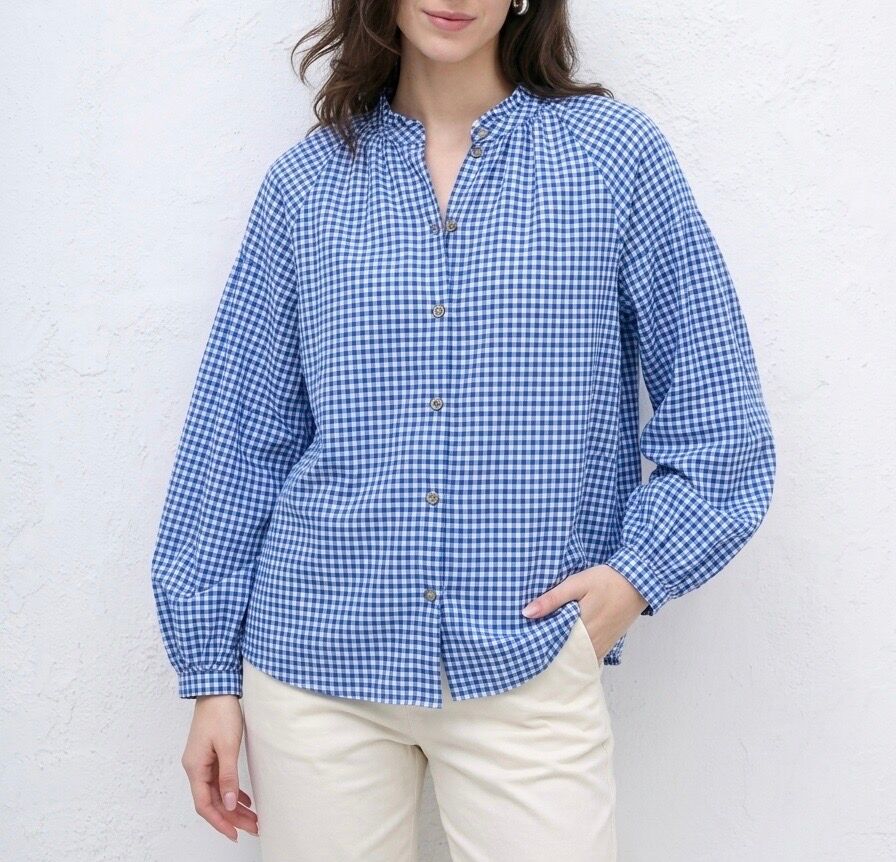 Long-sleeved shirt with buttoned cuffs, mandarin collar, and two-tone gingham pattern.