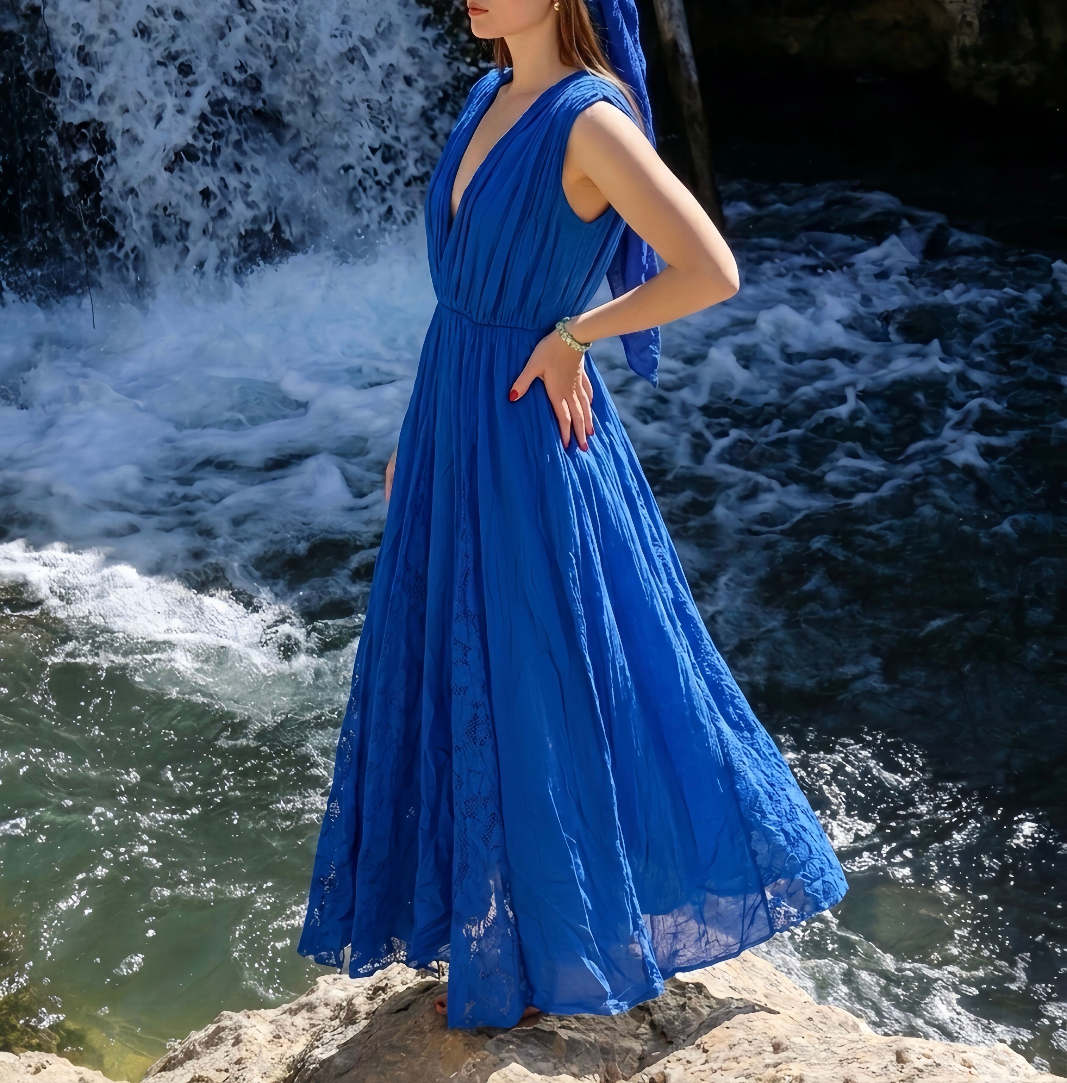 Long, lined bohemian dress with a V-neck, gathered bodice, elasticated waist, and vertical lace panels inserted at the hem.