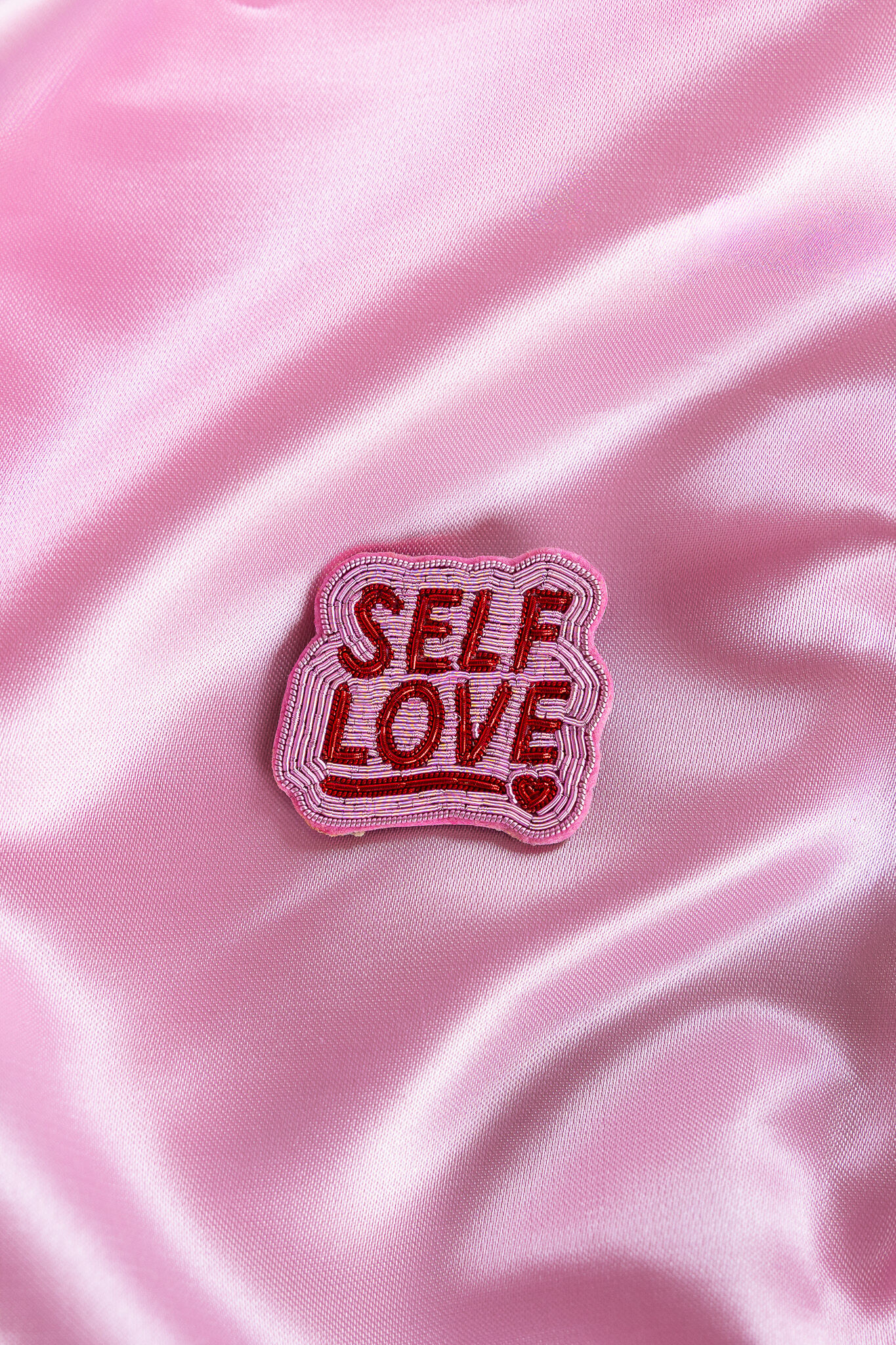 Broche rosa de amor propio