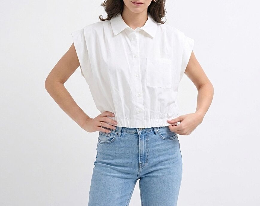 Short crop top shirt with structured dropped shoulders, gathered and elasticated hem, and a patch pocket on the left side of the chest.