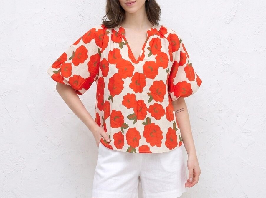 Loose-fitting blouse with a mandarin collar, short puff sleeves, and a floral print