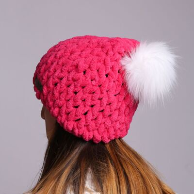 Bright pink winter textured hat with faux fur pom pom