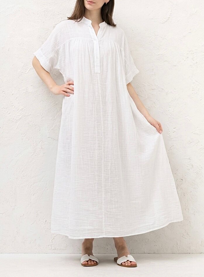 Long, loose-fitting tunic dress in linen and cotton blend with short, dropped sleeves and a mandarin collar opening to reveal a half-button placket.