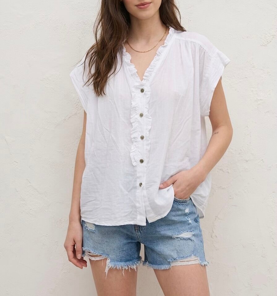 Loose-fitting, short-sleeved shirt with small ruffles edging the neckline and extending along the button placket.