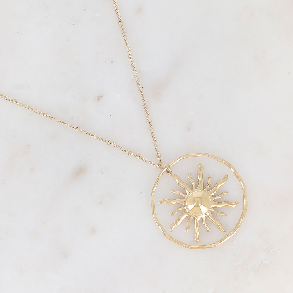 Necklace with textured ring and smooth sunburst