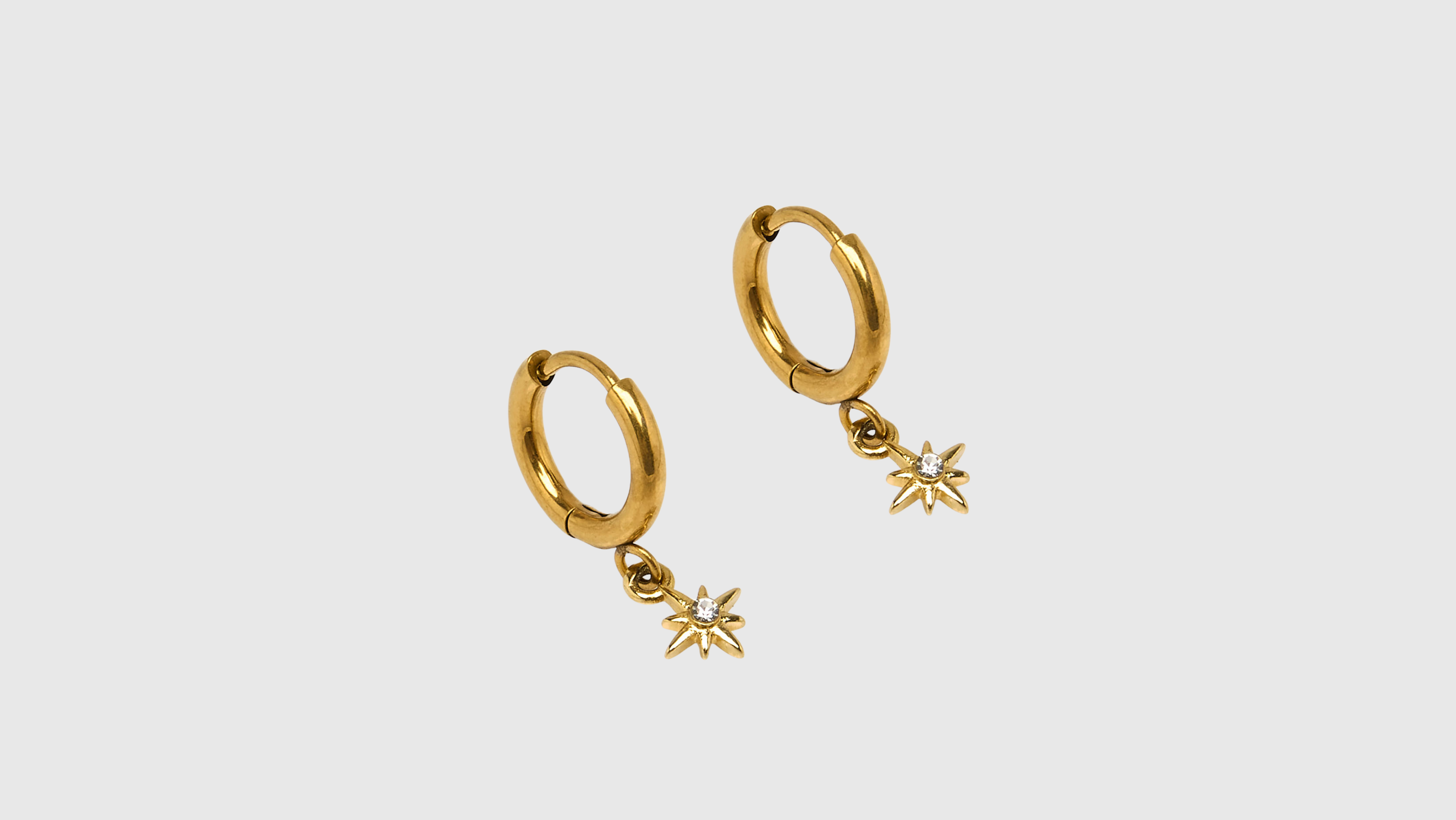 Stainless steel hoop earrings with a gold star and rhinestones