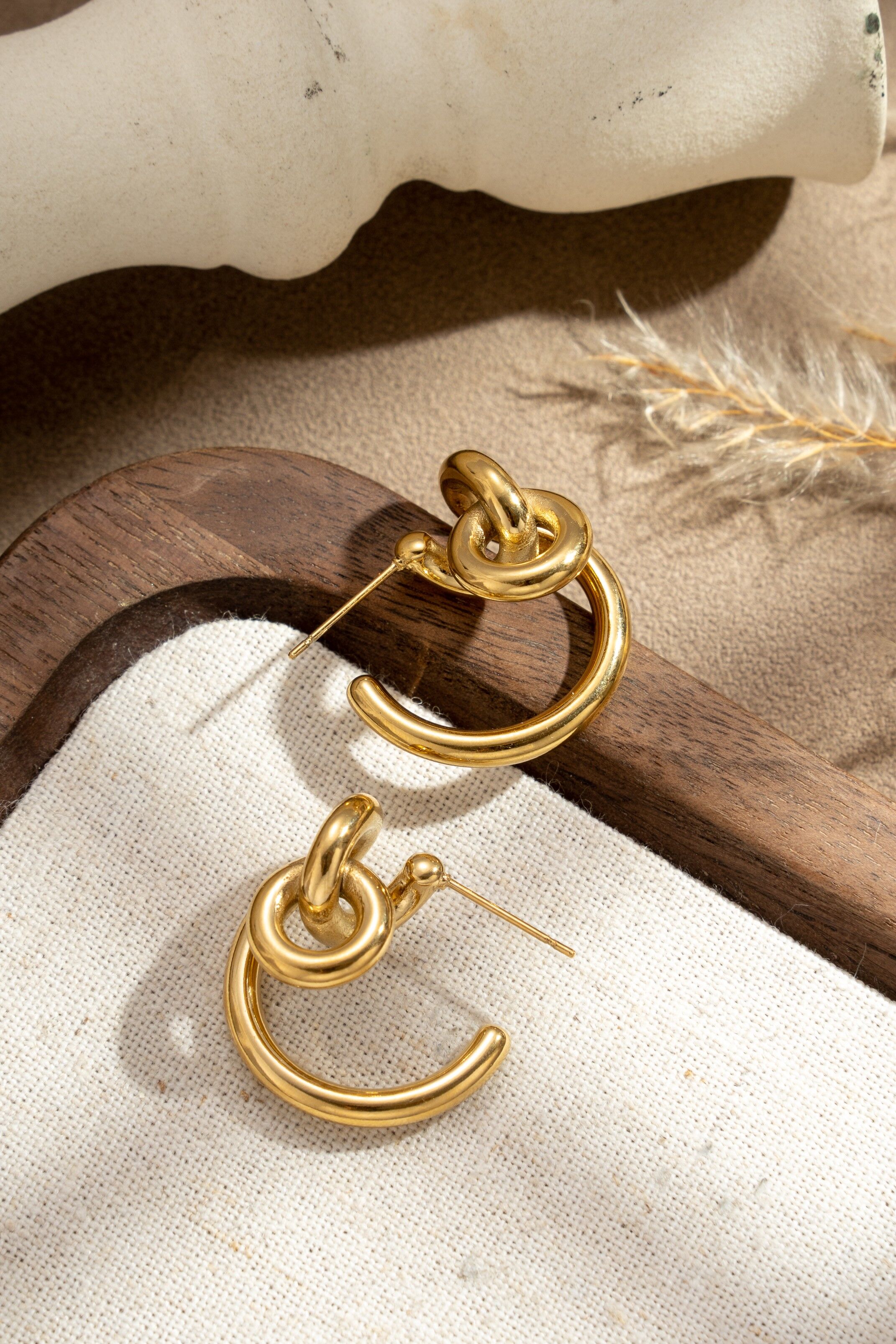 Gold-plated stainless steel hoop earrings with modern interlocking rings