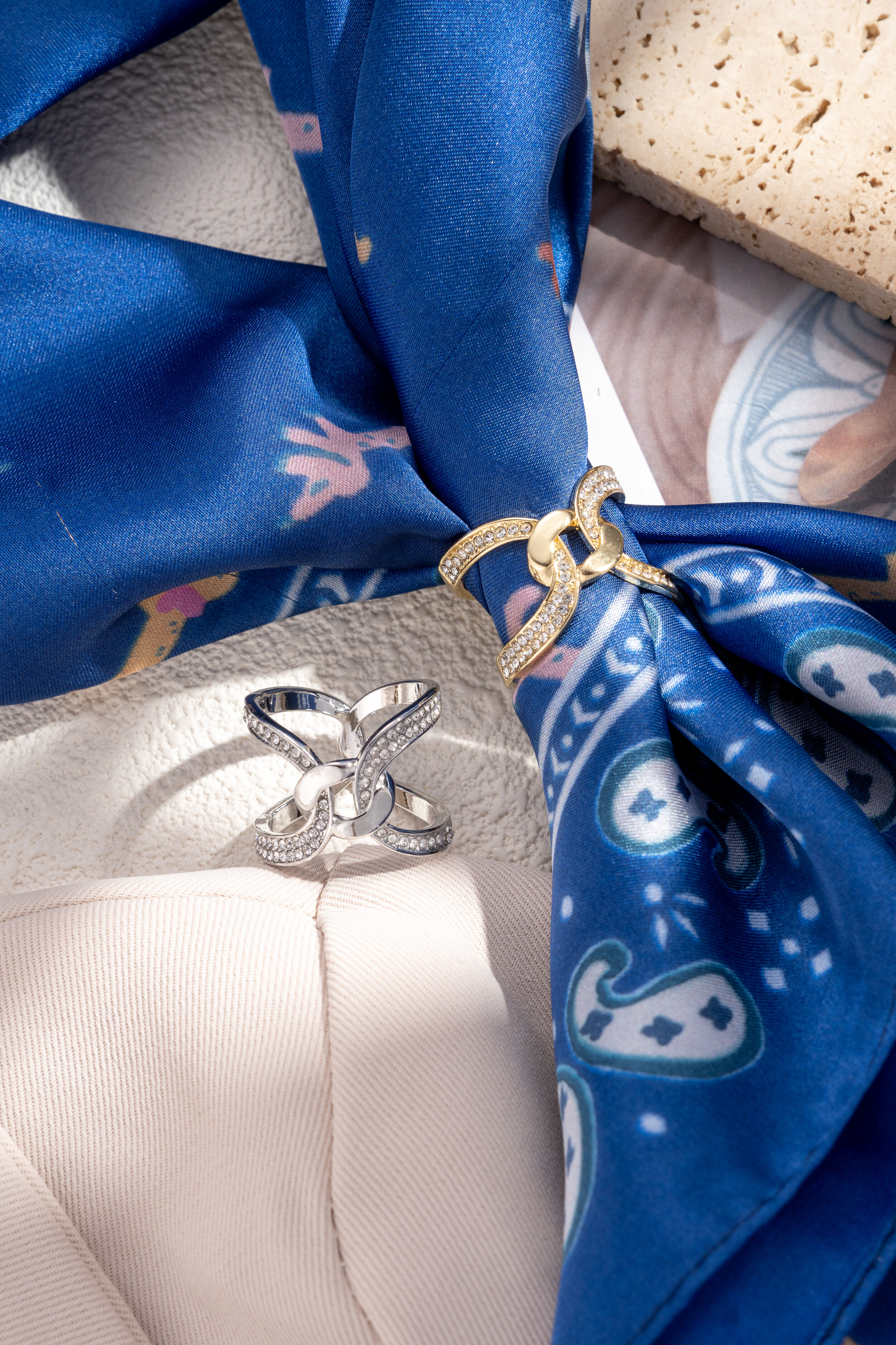 Elegant gold and silver metal scarf buckle with intertwined crystal