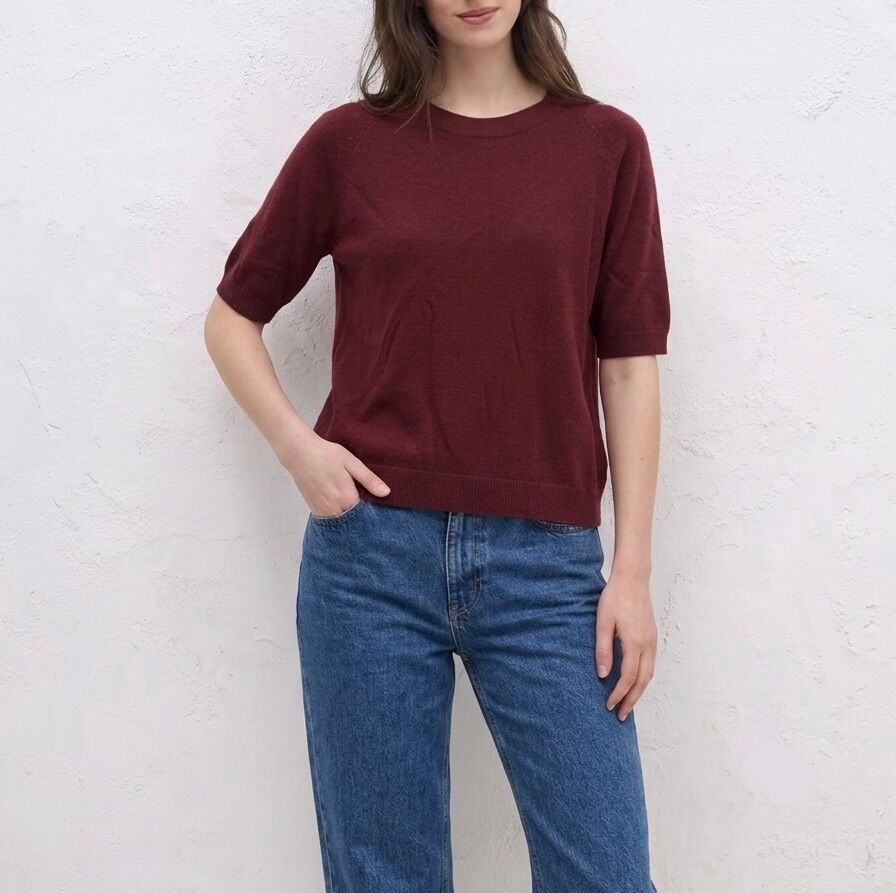 Fine knit sweater with short sleeves, crew neck, and ribbed trim.