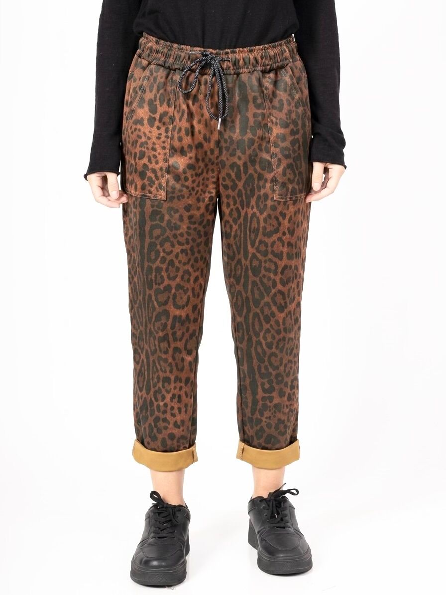 Suede trousers with elasticated waist and drawstring, two large patch pockets on the front, leopard print