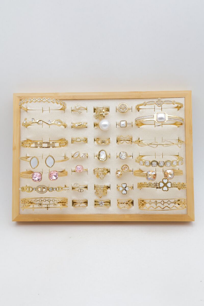 Assortment of 21 rings and 14 bangles with rhinestones, pearls and clovers