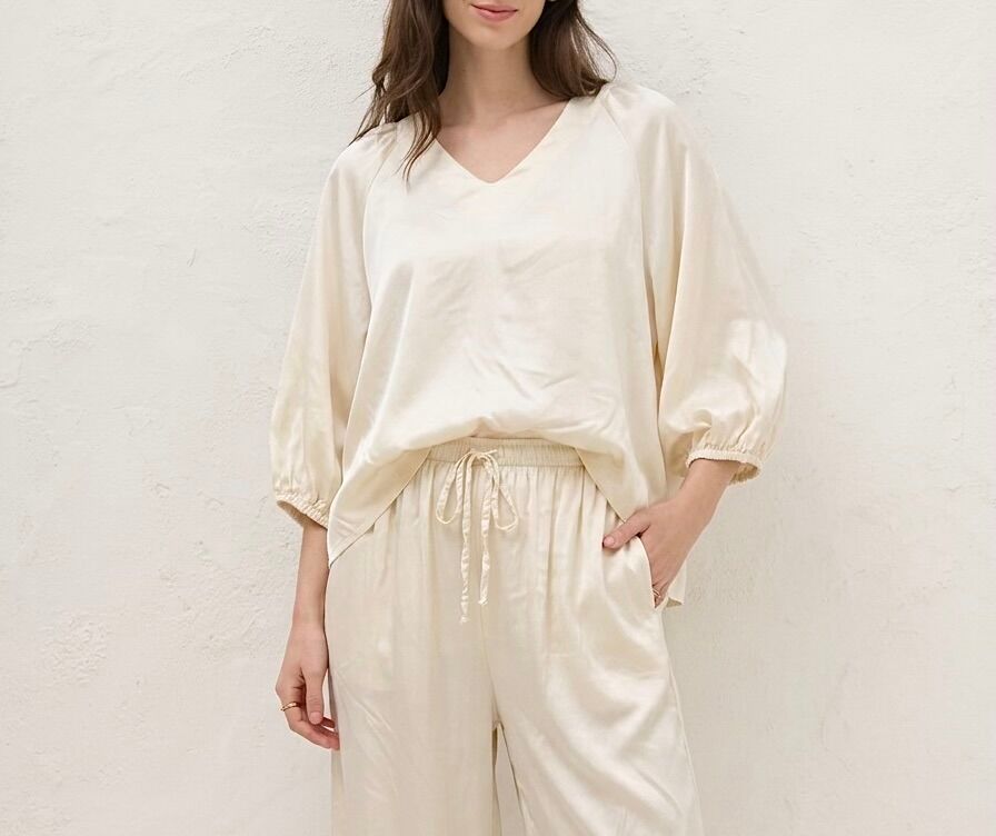 Flowy satin silk blouse with V-neck, 3/4 sleeves, and elasticated cuffs.
