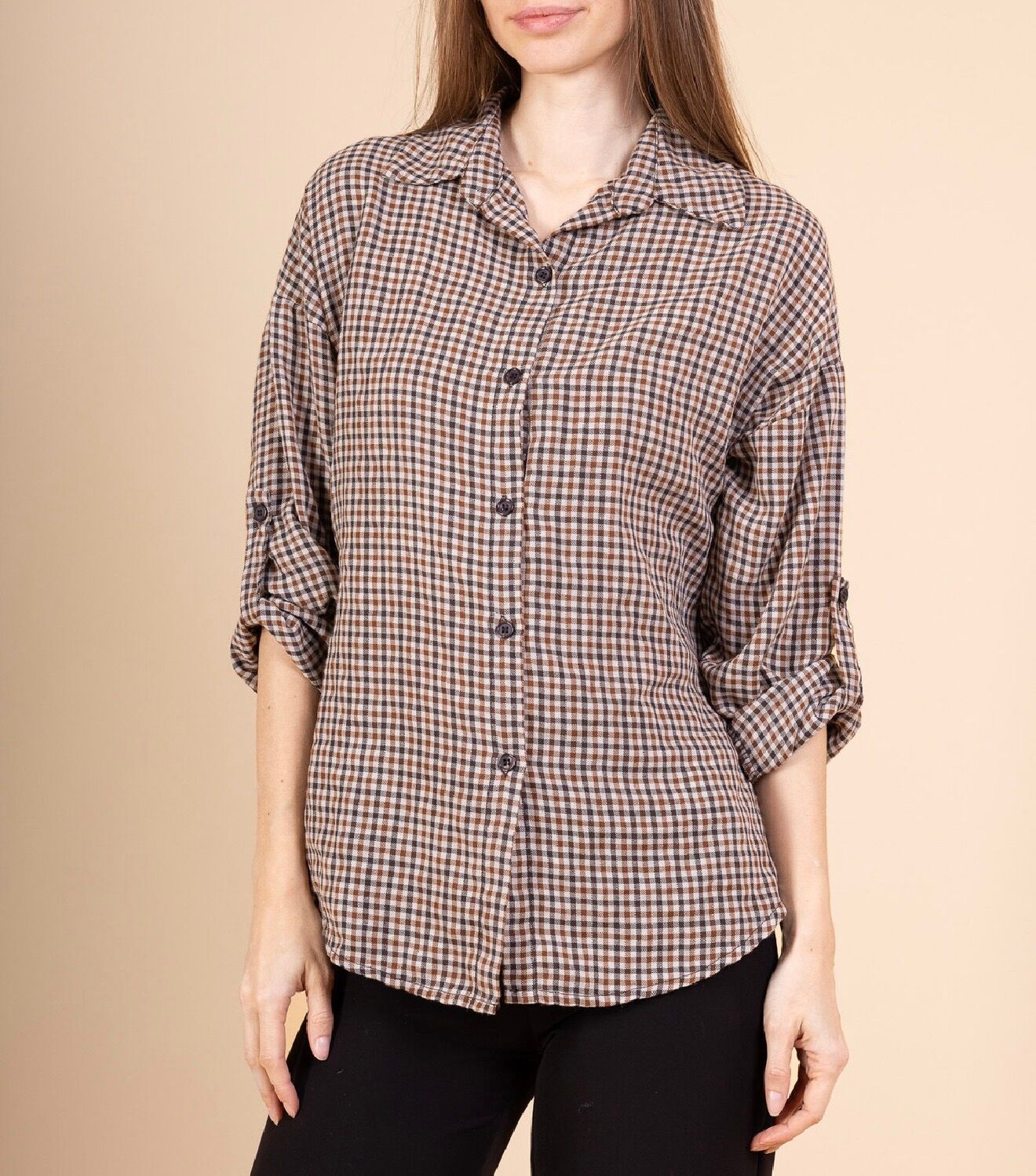 Long-sleeved shirt with roll-up sleeves, small button tabs inside, and a small checkered patterned collar.