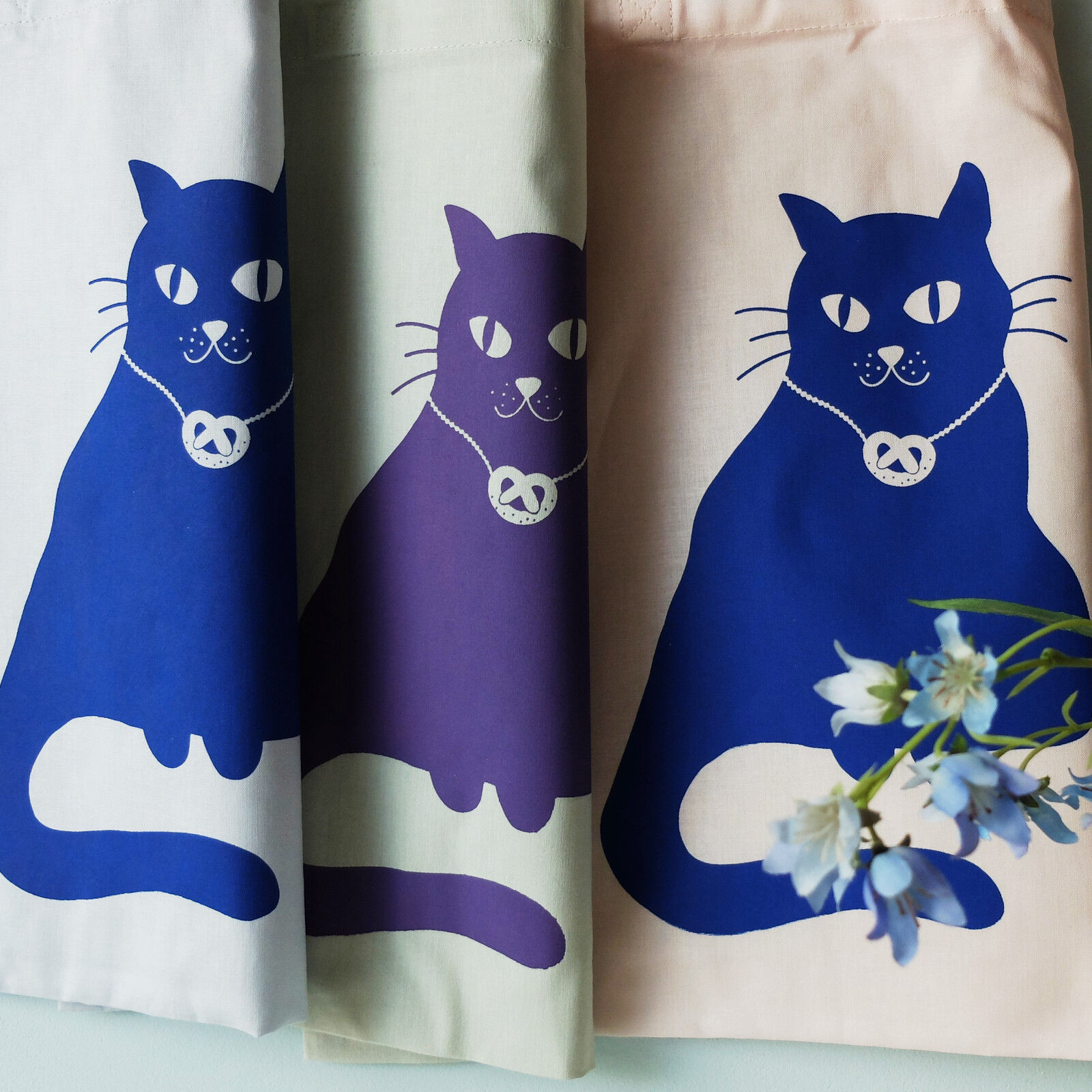 Hand-printed fabric bag with a cat motif and pretzel