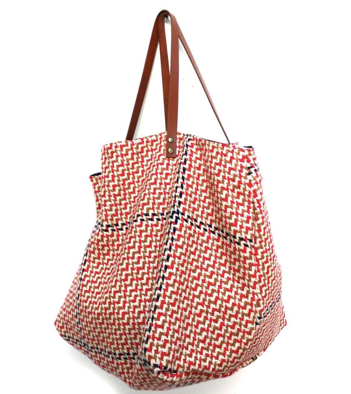 Blaue, rote, braune Einkaufstasche aus Stoff mit schwarzem Innenfutter.