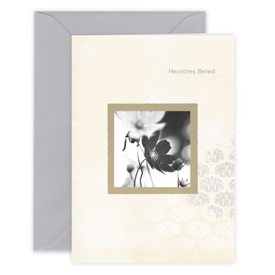 Mourning card "Warm condolences" with black and white floral motif and subtle beige tones.