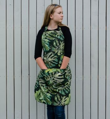 Tablier à thème botanique pour femme avec des motifs de feuilles vertes et deux poches avant 1